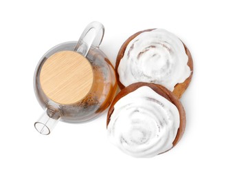 Photo of Tasty cinnamon rolls with cream and tea isolated on white, top view