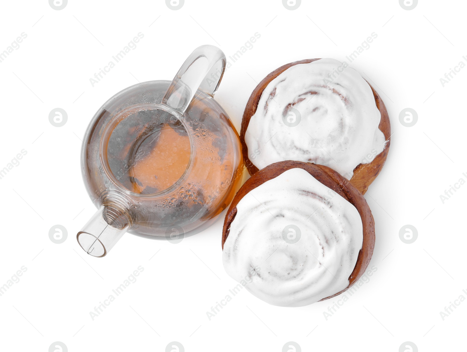 Photo of Tasty cinnamon rolls with cream and tea isolated on white, top view