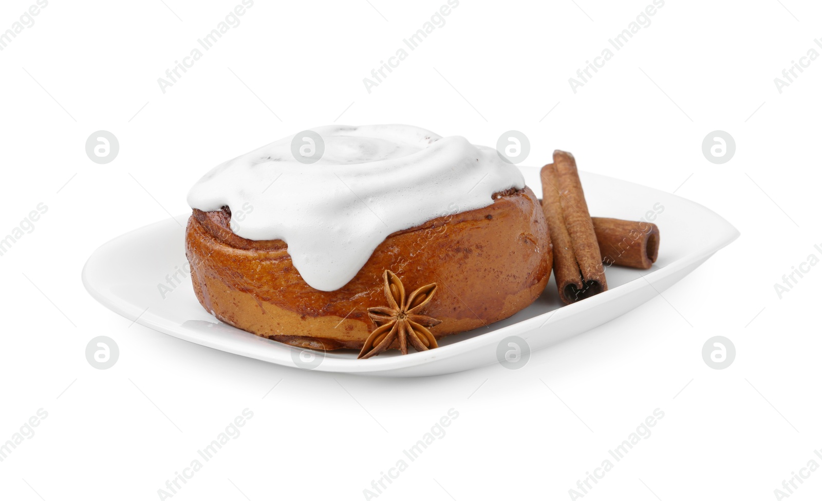 Photo of Tasty cinnamon roll with cream and spices isolated on white