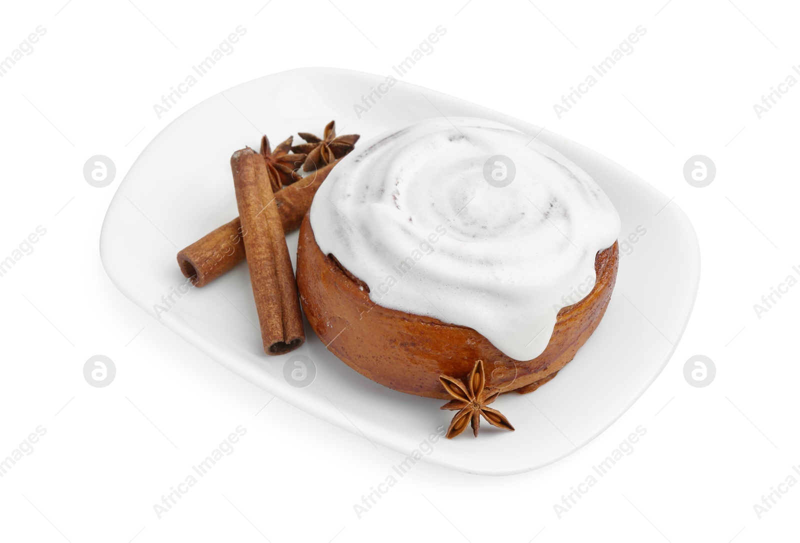 Photo of Tasty cinnamon roll with cream and spices isolated on white