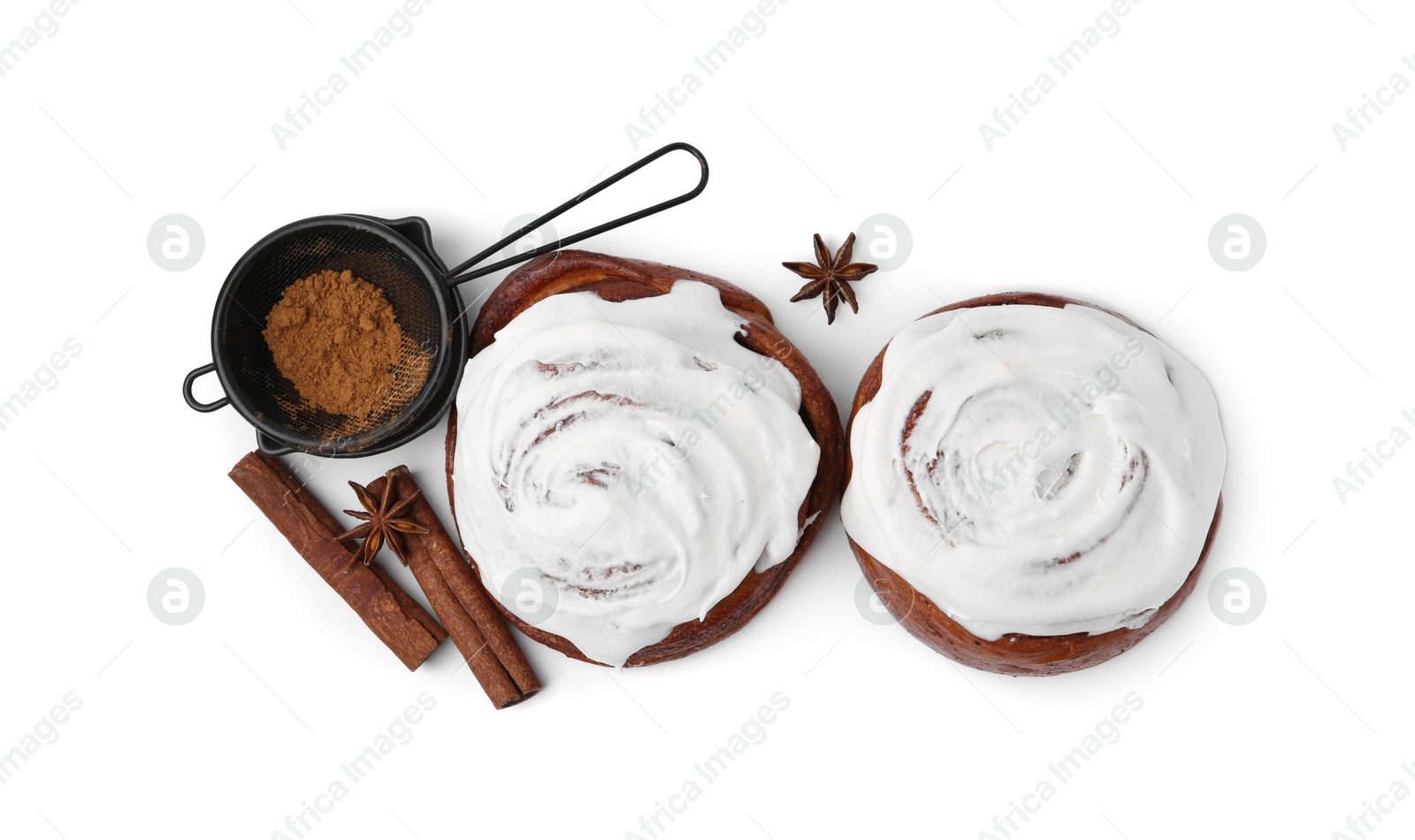 Photo of Tasty cinnamon rolls with cream and spices isolated on white, top view