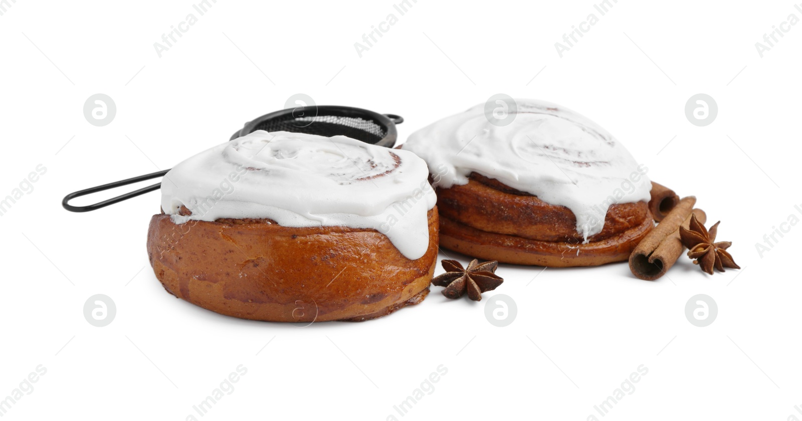 Photo of Tasty cinnamon rolls with cream and spices isolated on white