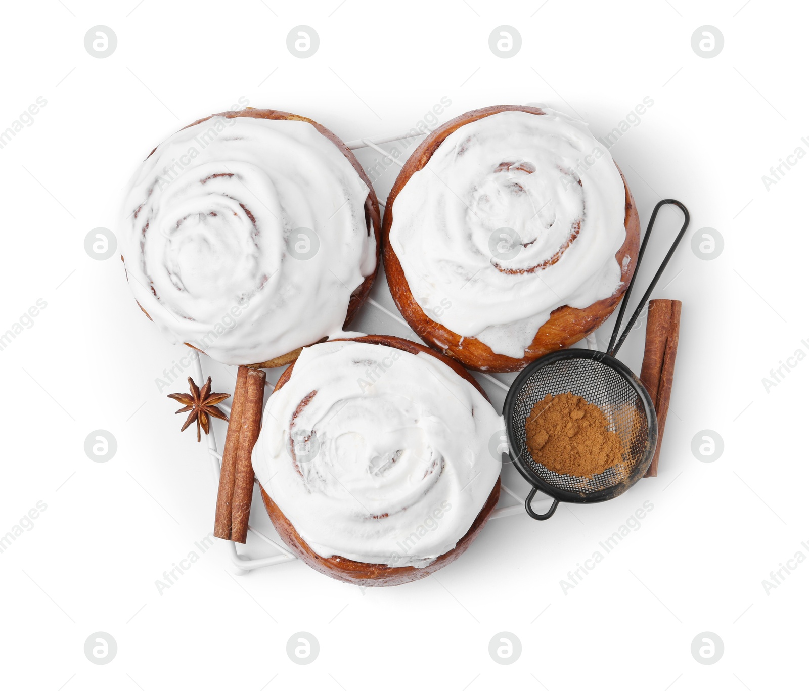 Photo of Tasty cinnamon rolls with cream and spices isolated on white, top view