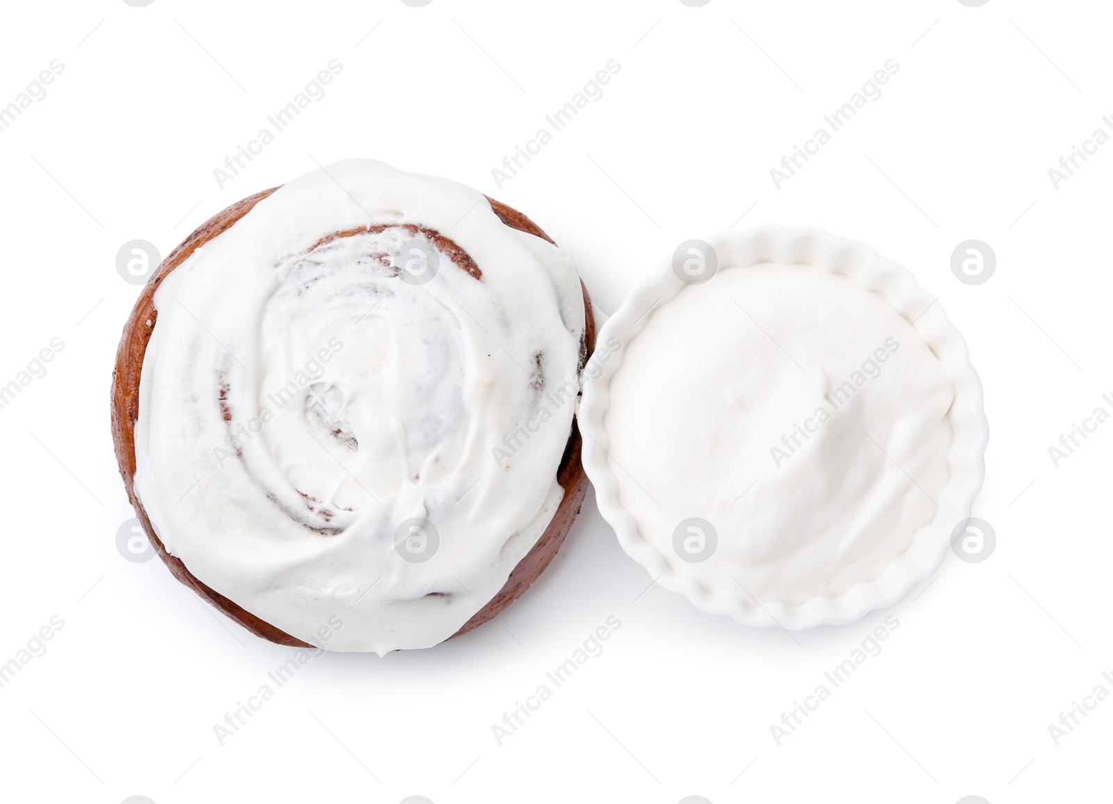 Photo of Tasty cinnamon roll with cream isolated on white, top view