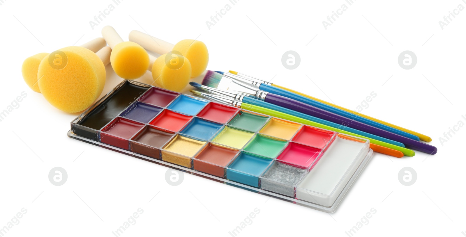 Photo of Bright face paint palette, brushes and sponges isolated on white