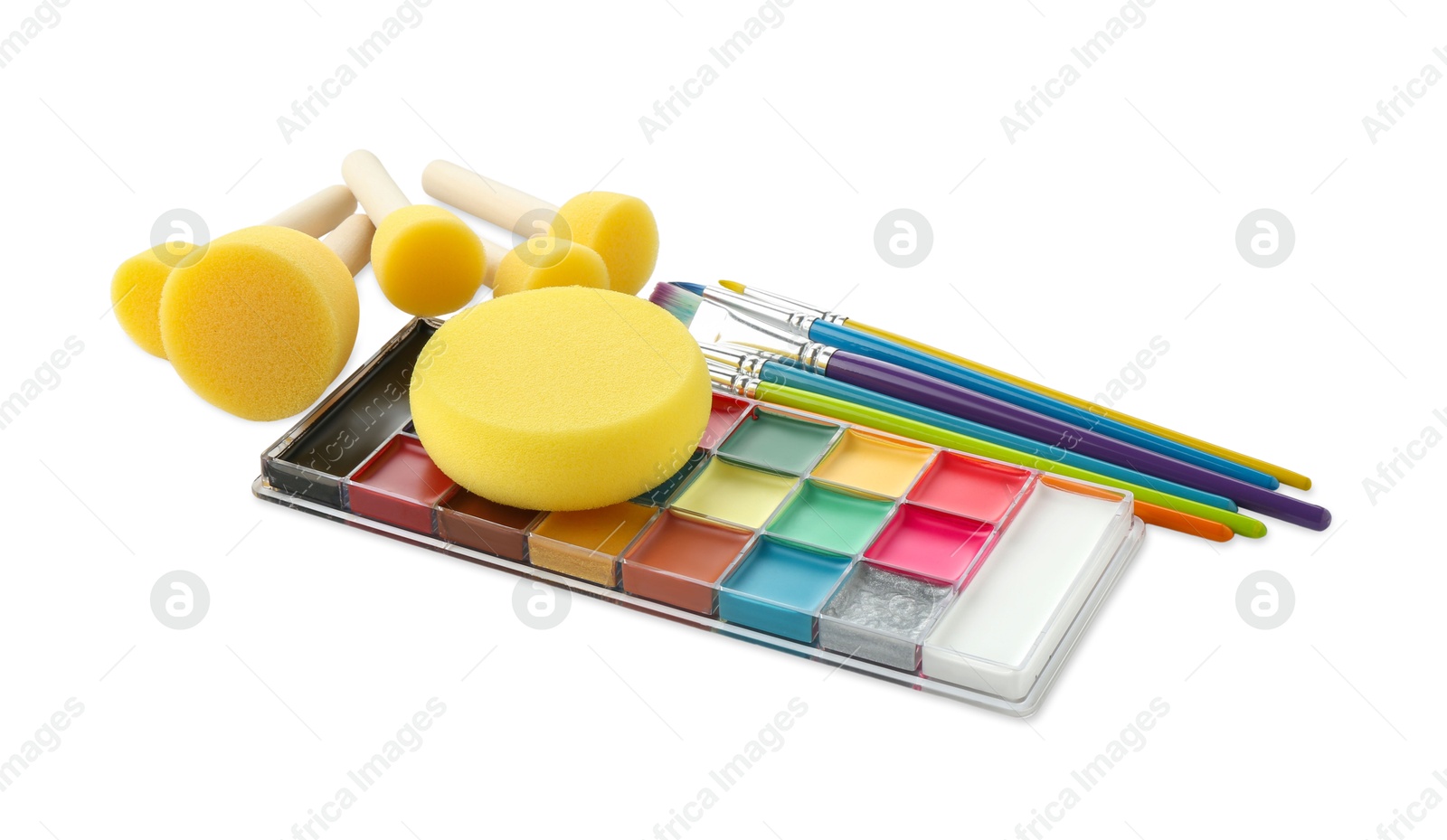 Photo of Bright face paint palette, brushes and sponges isolated on white