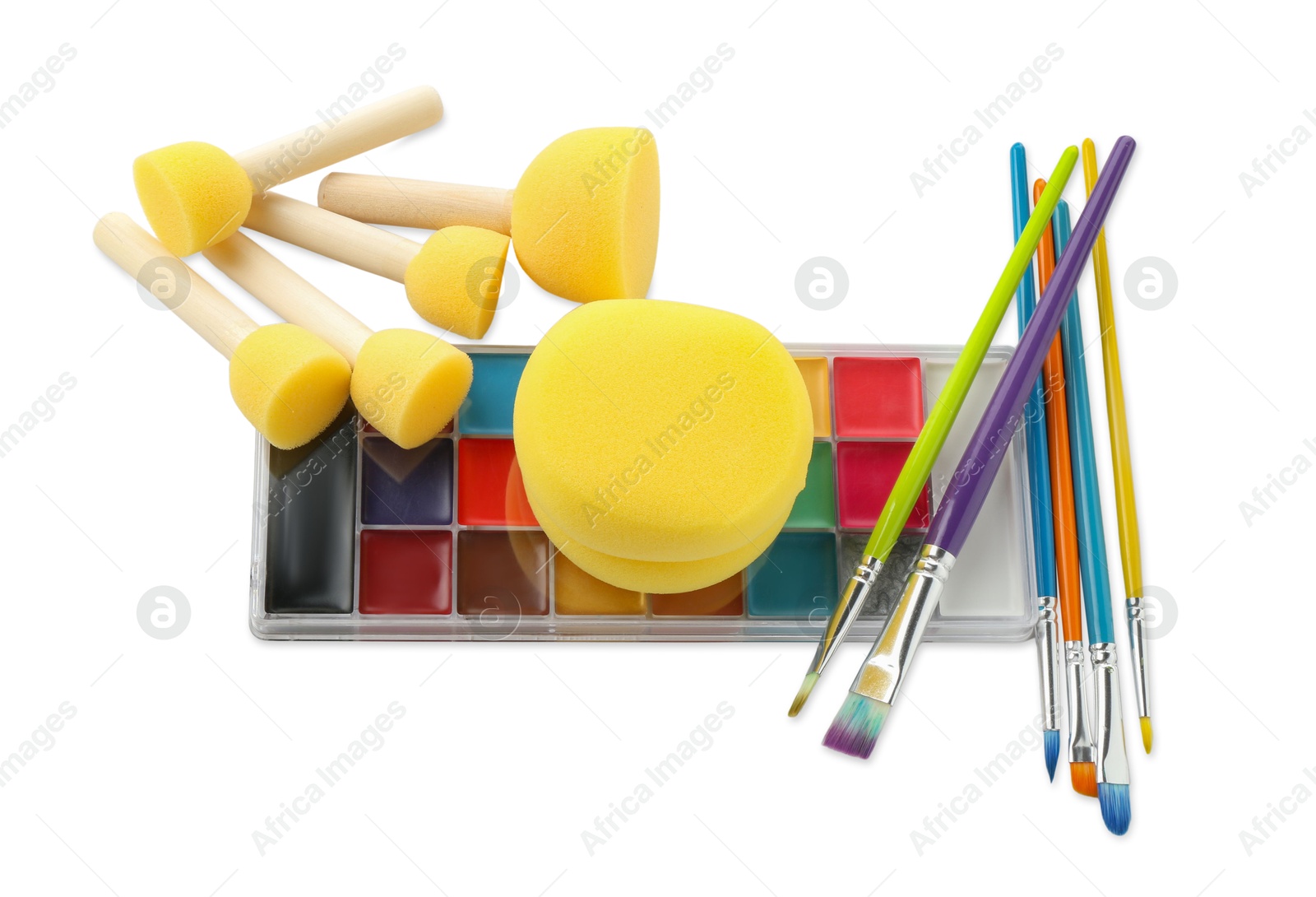 Photo of Bright face paint palette, brushes and sponges isolated on white, top view