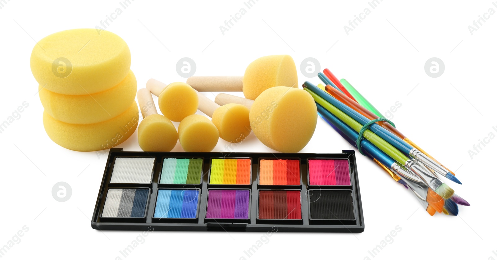 Photo of Bright face paint palette, brushes and sponges isolated on white