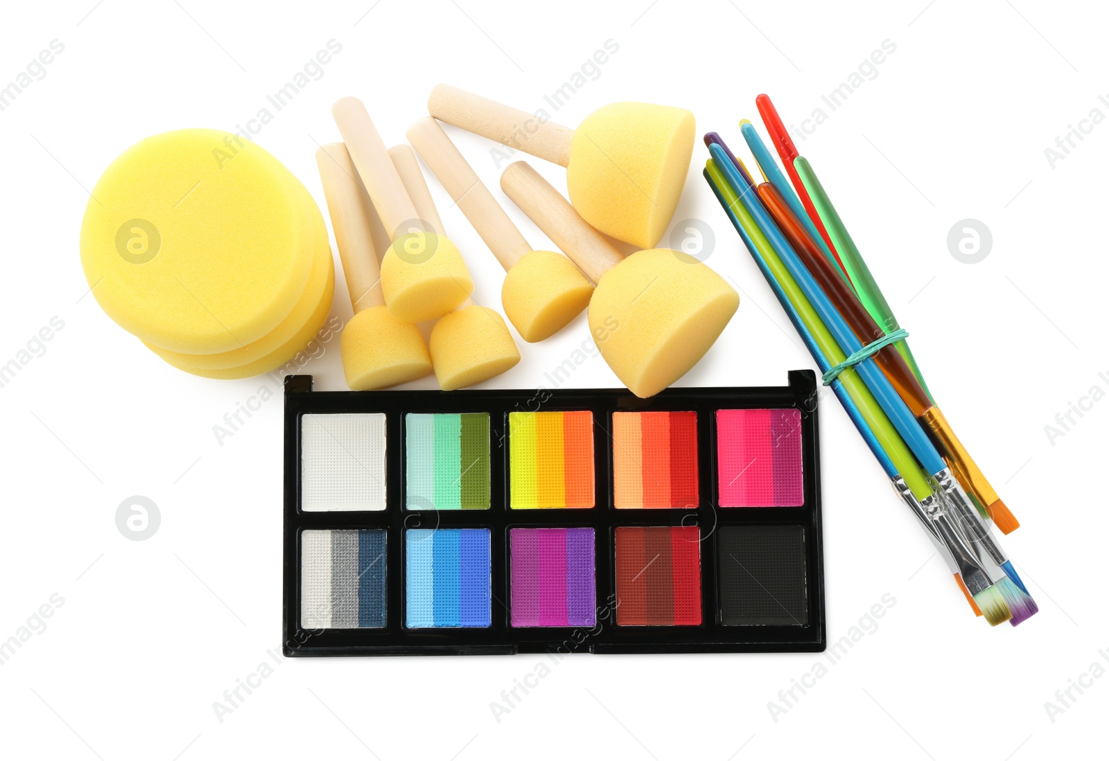 Photo of Bright face paint palette, brushes and sponges isolated on white, top view