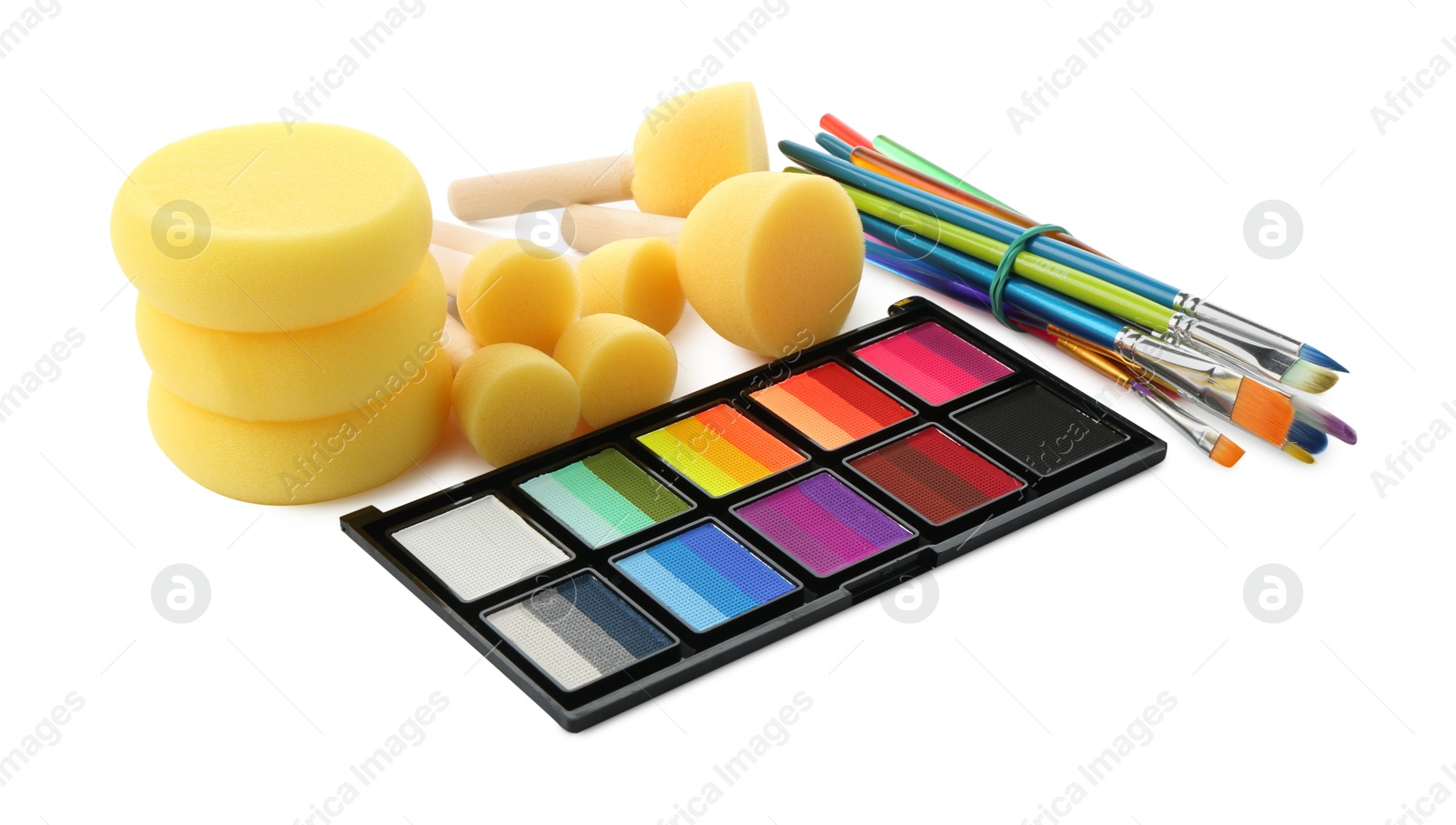 Photo of Bright face paint palette, brushes and sponges isolated on white