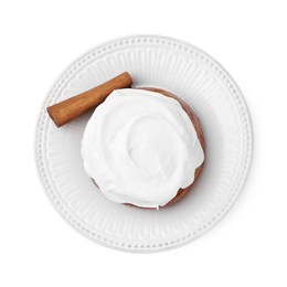 Photo of Tasty cinnamon roll with cream and stick isolated on white, top view