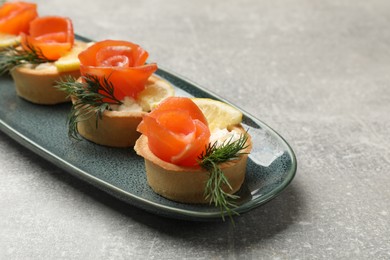 Photo of Tasty tartlets with delicious filling on grey table, closeup. Space for text