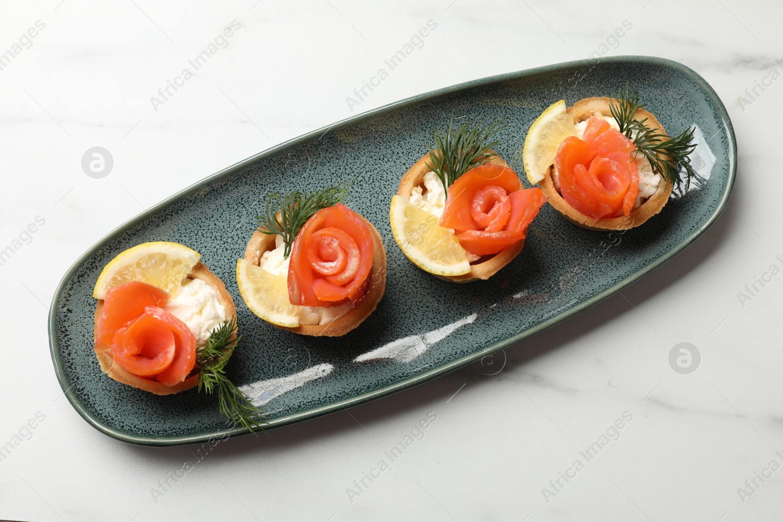 Photo of Tasty tartlets with delicious filling on white marble table, top view