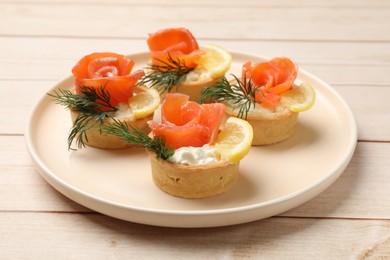 Photo of Tasty tartlets with delicious filling on wooden table, closeup