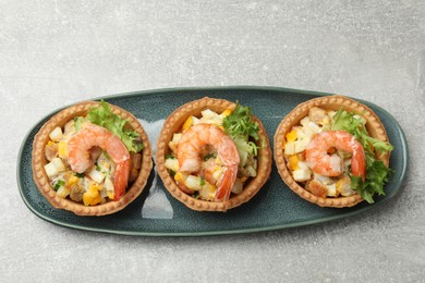 Photo of Tartlets with delicious filling on grey table, top view