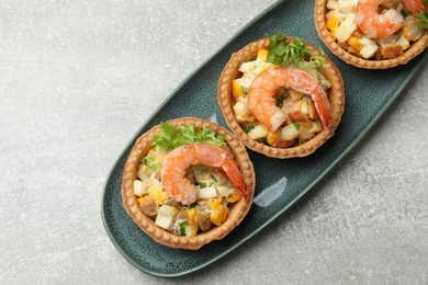 Photo of Tartlets with delicious filling on grey table, top view