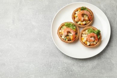 Photo of Tartlets with delicious filling on grey table, top view. Space for text