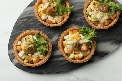 Photo of Tartlets with delicious filling on white marble table, top view