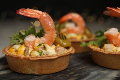 Photo of Tartlets with delicious filling on table, closeup. Bokeh effect