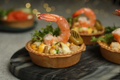 Photo of Tartlets with delicious filling on table, closeup. Bokeh effect