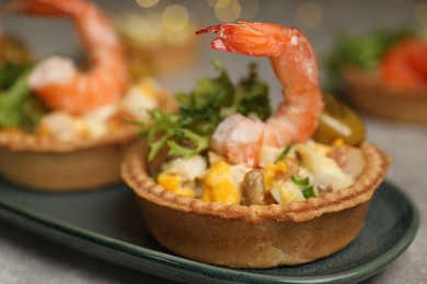 Photo of Tartlets with delicious filling on table, closeup. Bokeh effect