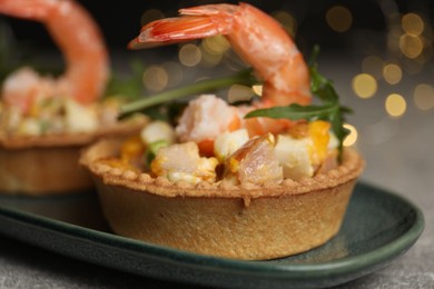 Photo of Tartlets with delicious filling on table, closeup. Bokeh effect