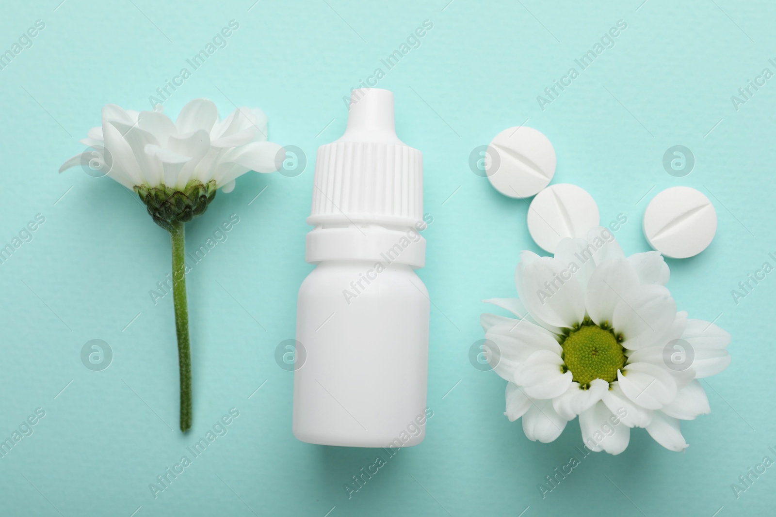 Photo of Allergy treatment. Nasal drops, pills and flowers on light blue background, flat lay