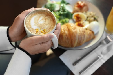 Photo of Woman having tasty breakfast in cafe, closeup