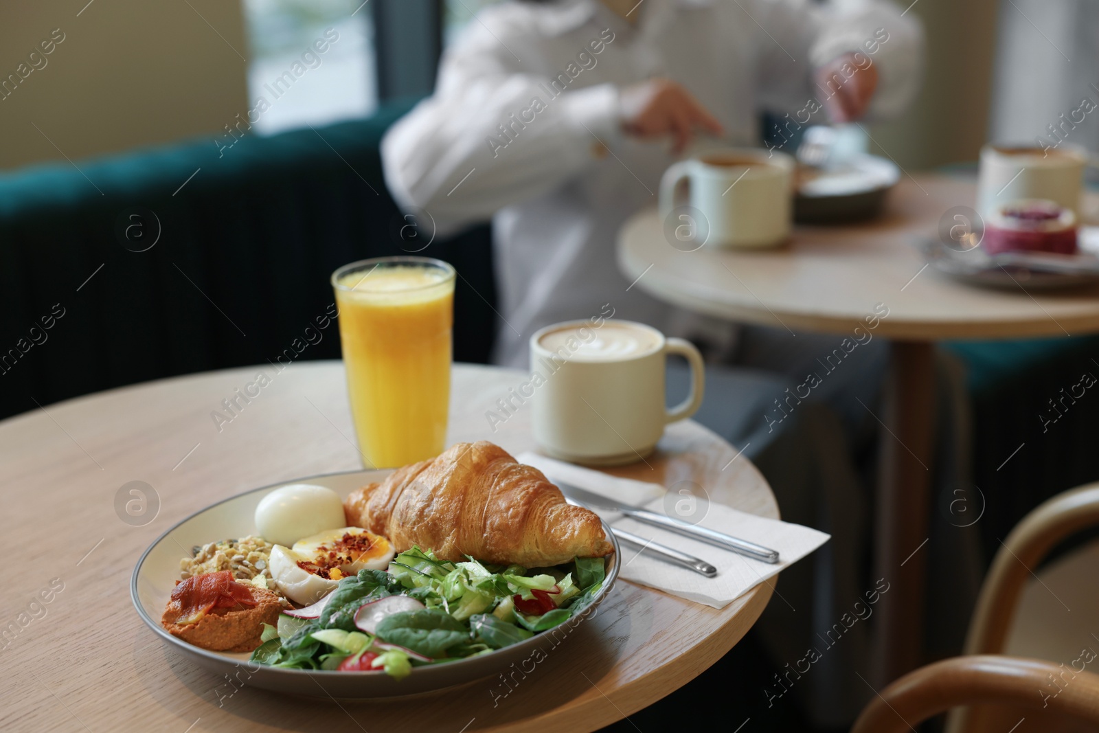 Photo of Woman having tasty breakfast in cafe, selective focus