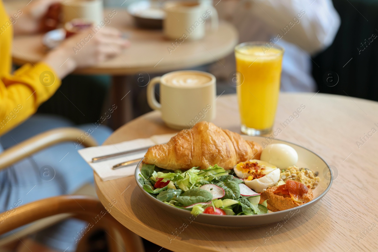 Photo of Women having tasty breakfast in cafe, selective focus