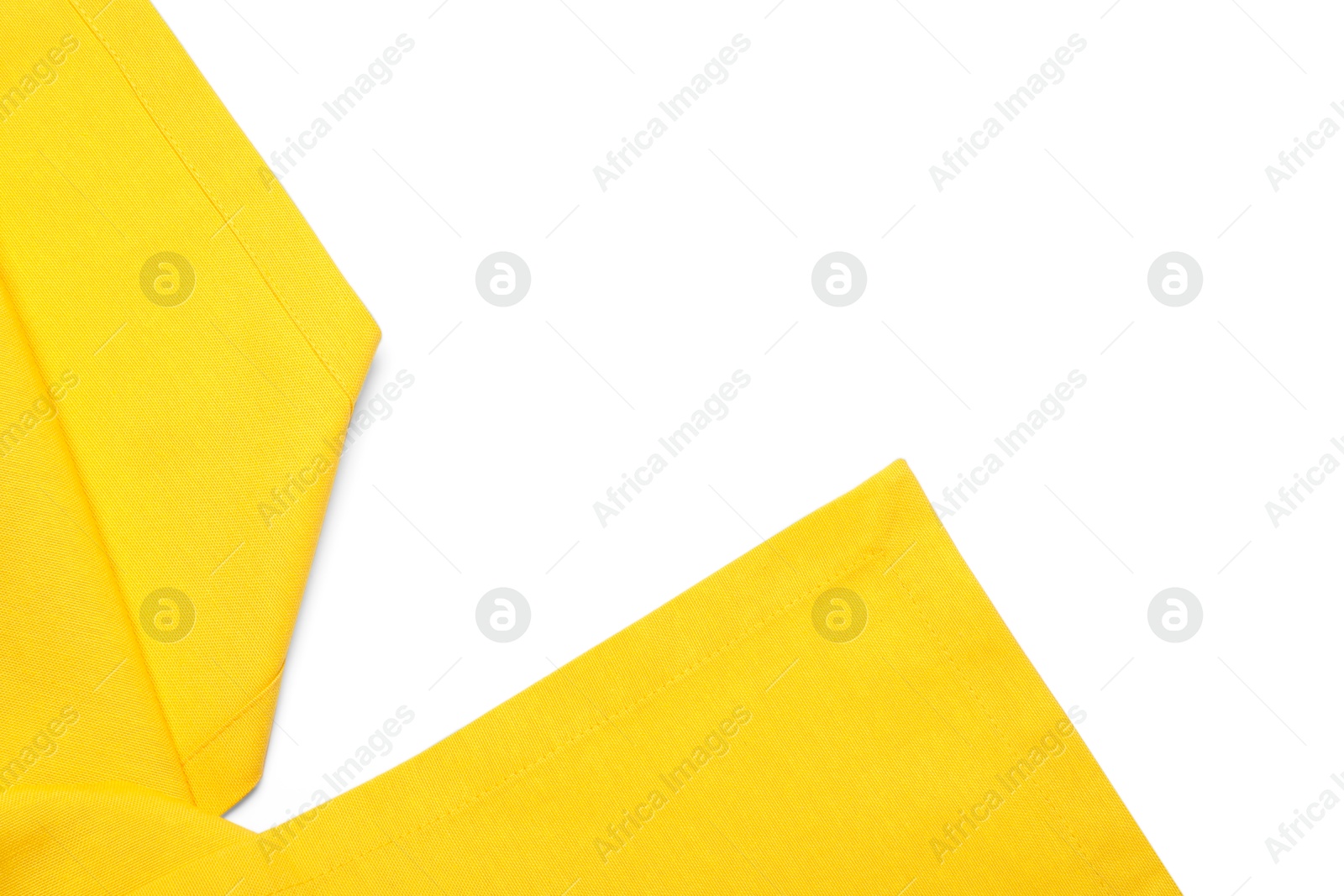 Photo of Yellow tablecloth isolated on white, top view