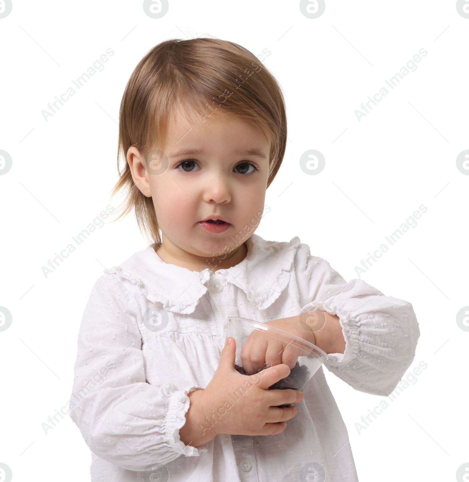 Photo of Cute little baby girl eating snack on white background