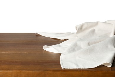 Photo of Light tablecloth on wooden table against white background, closeup