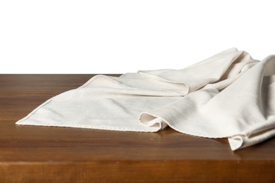 Photo of Crumpled tablecloth on wooden table against white background, closeup