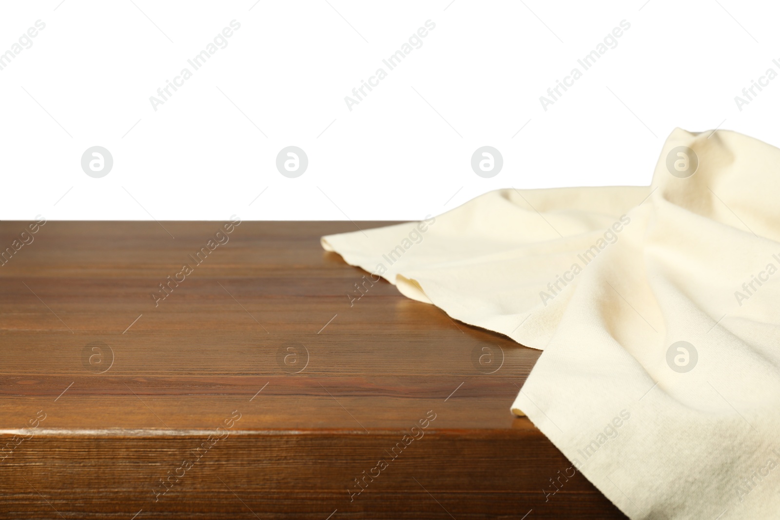 Photo of Beige tablecloth on wooden table against white background, closeup