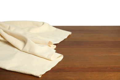 Photo of Beige tablecloth on wooden table against white background, closeup