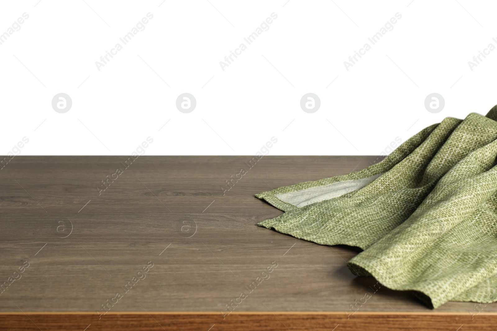 Photo of Green tablecloth on wooden table against white background, closeup