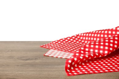 Photo of Red checkered tablecloth on wooden table against white background, closeup