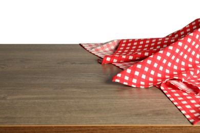 Photo of Red checkered tablecloth on wooden table against white background, closeup