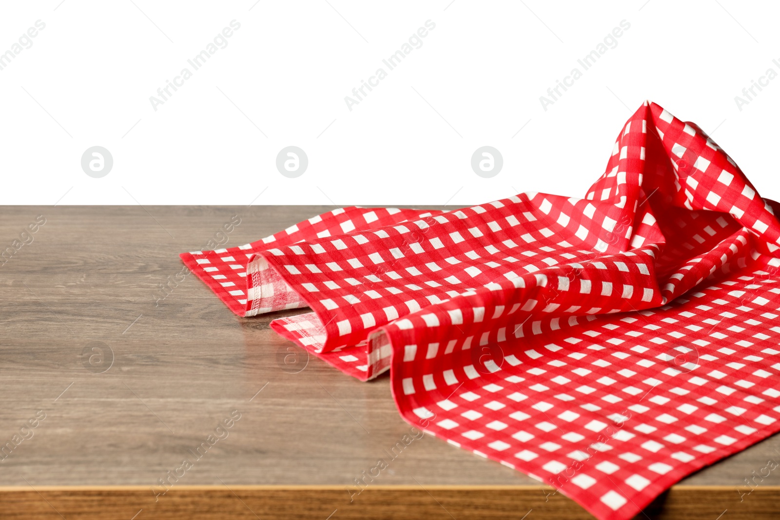 Photo of Red checkered tablecloth on wooden table against white background, closeup