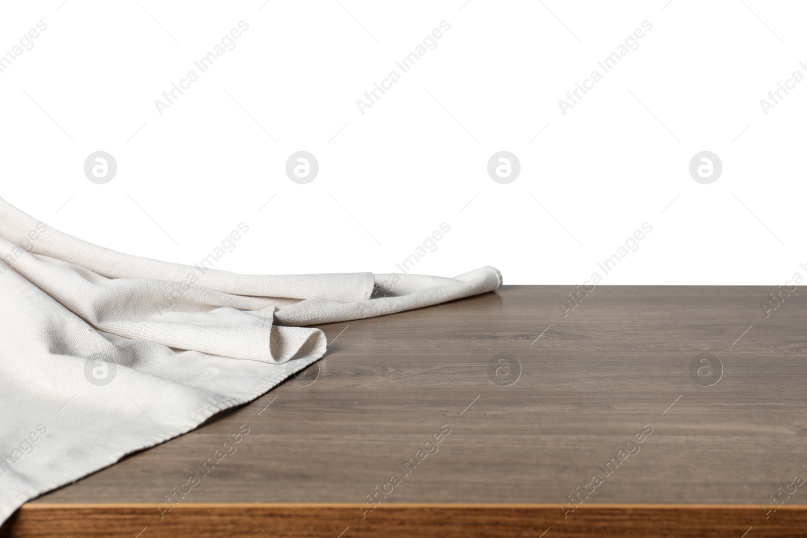 Photo of Light tablecloth on wooden table against white background, closeup