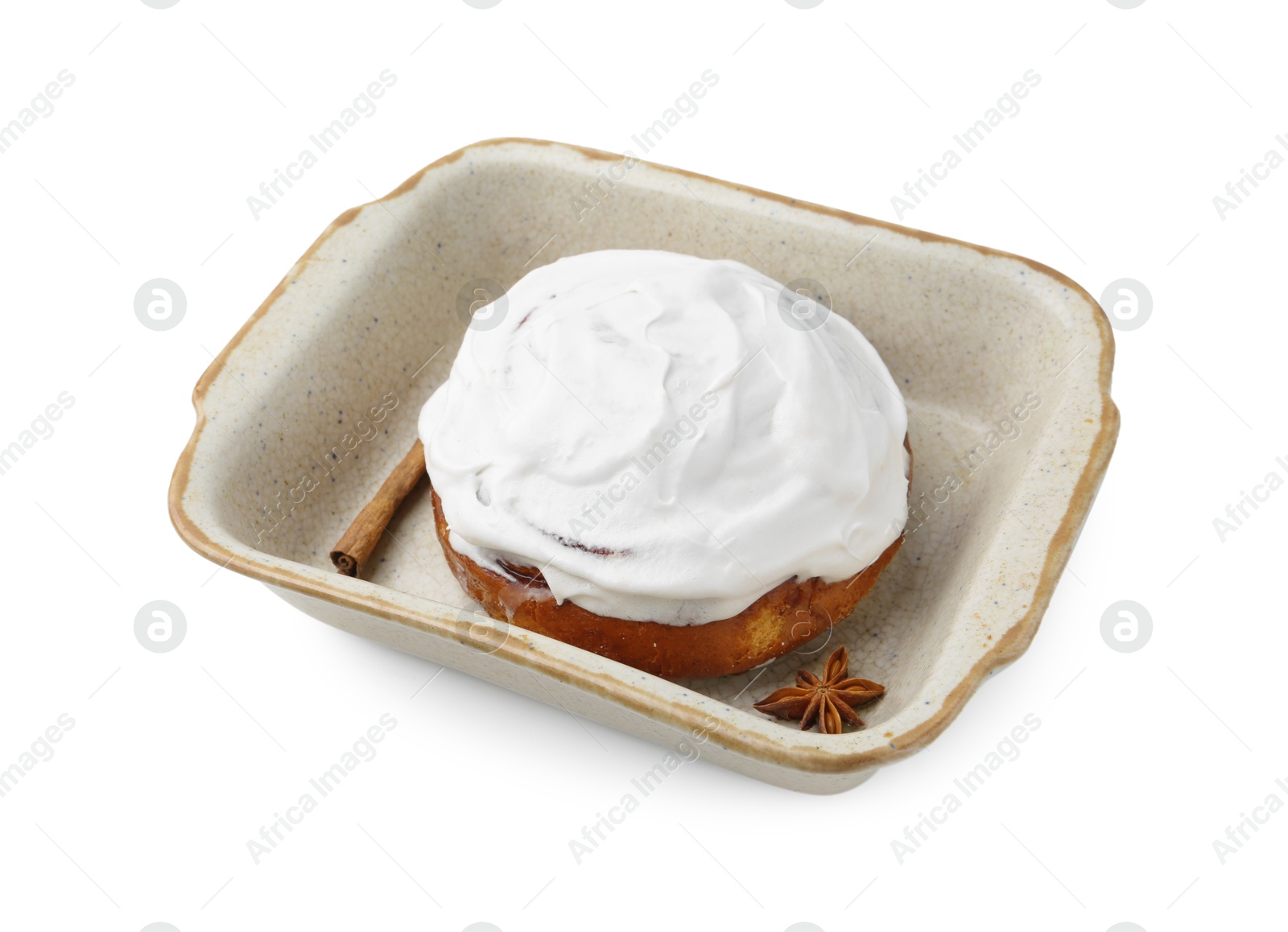 Photo of Tasty cinnamon roll with cream and spices in baking dish isolated on white