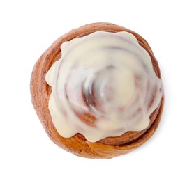 Photo of Tasty cinnamon roll with cream isolated on white, top view