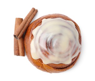 Photo of Tasty cinnamon roll with cream and spices isolated on white, top view