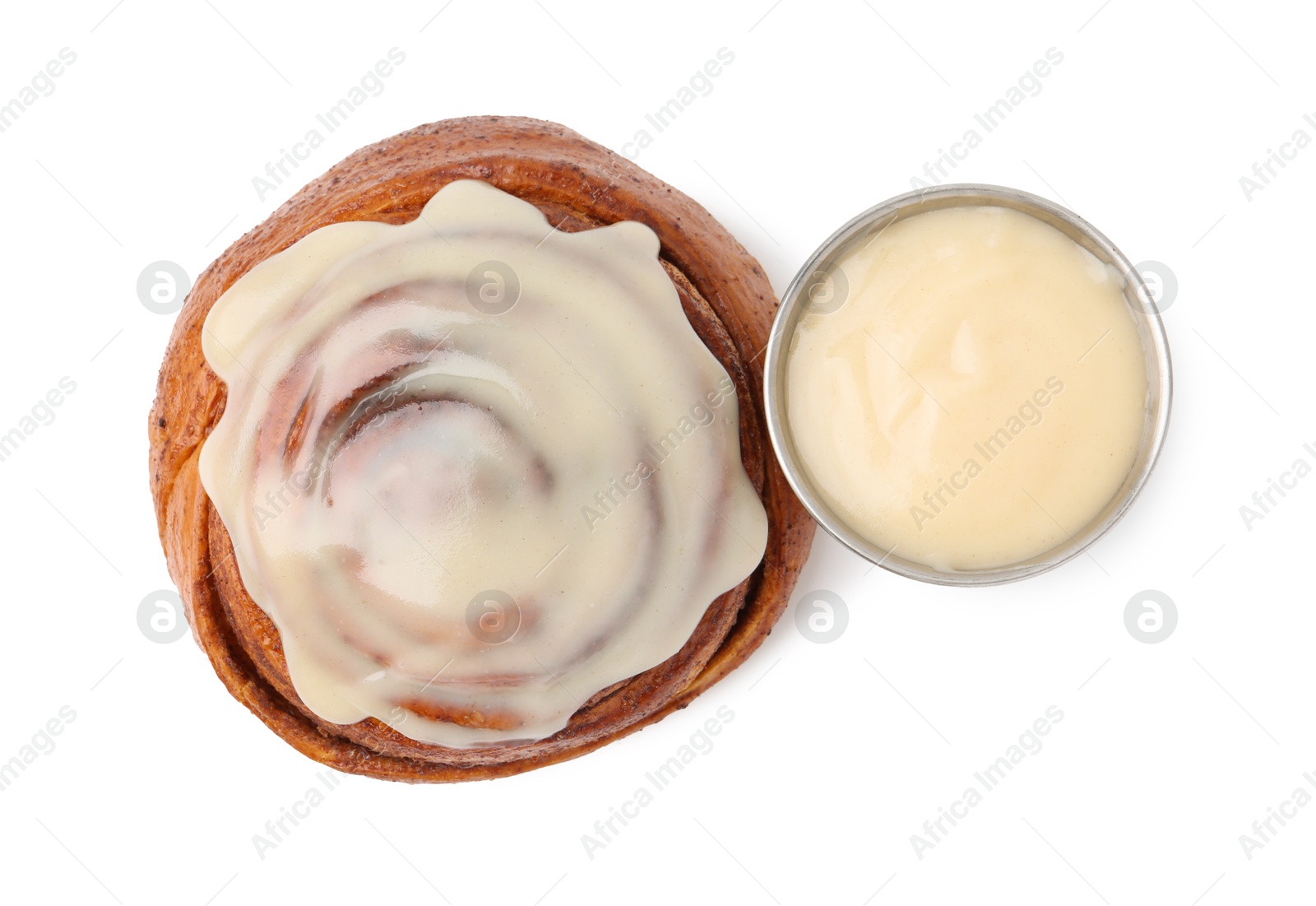 Photo of Tasty cinnamon roll with cream isolated on white, top view