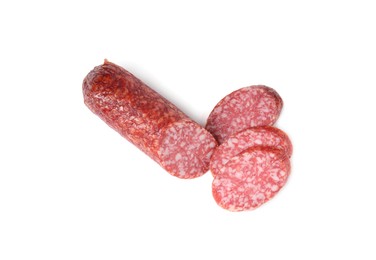 Photo of Pieces of delicious smoked sausage isolated on white, top view