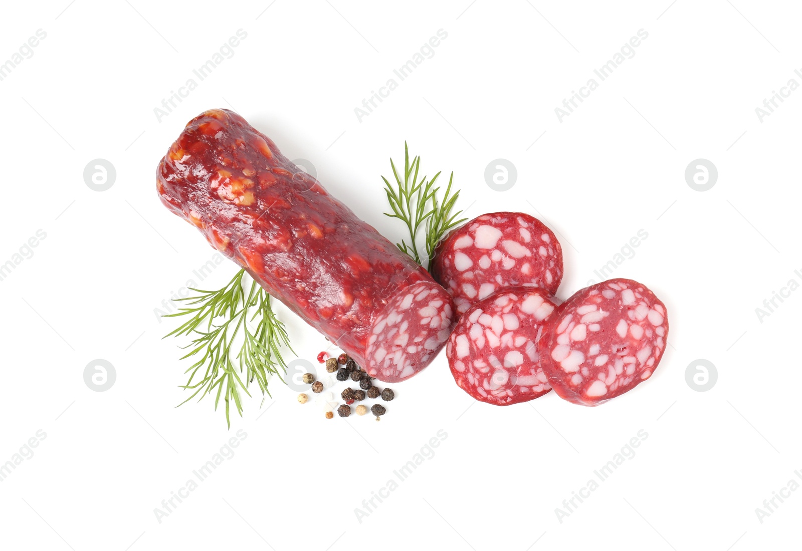 Photo of Delicious dry cured sausage and spices isolated on white, top view