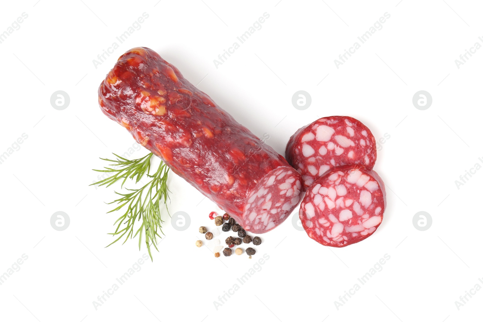 Photo of Delicious dry cured sausage and spices isolated on white, top view