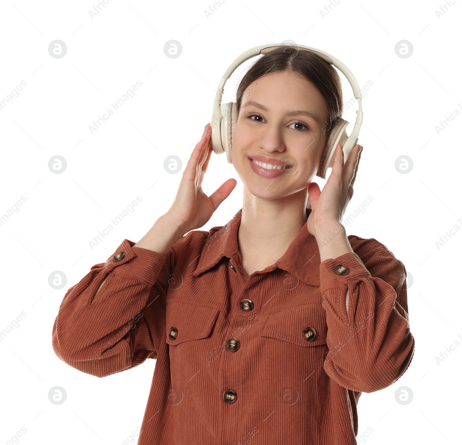 Photo of Portrait of smiling teenage girl listening to music on white background