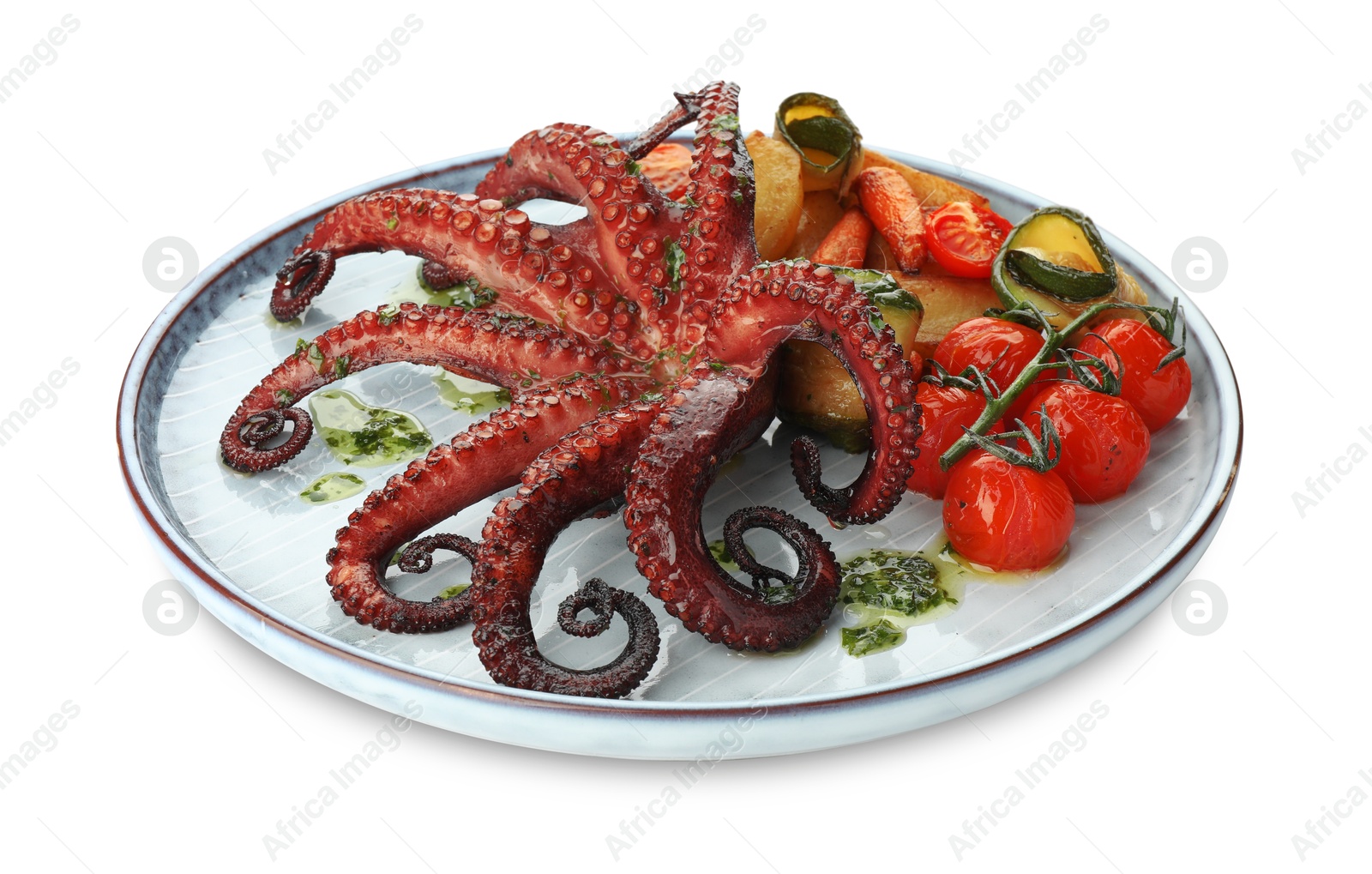 Photo of Fried octopus with herb sauce and vegetables isolated on white